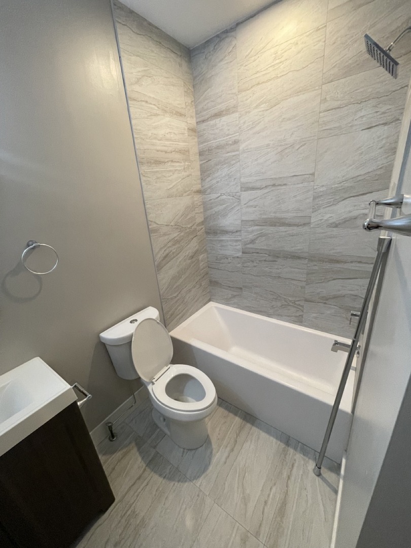 215 South Hamilton Avenue, Unit 1N Chicago, IL 60612 - Photo 9 of 23 a bathroom with a sink and a toilet