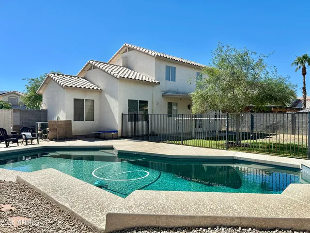 a view of a backyard with sitting area and tub