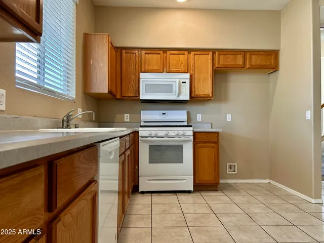 a kitchen with a sink cabinets and a stove top oven