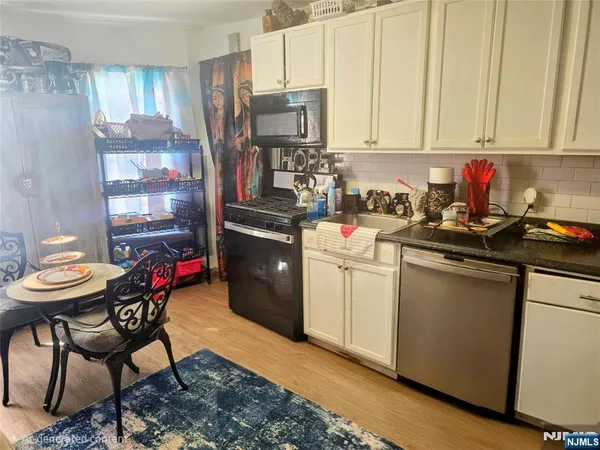 a kitchen with a sink cabinets and appliances