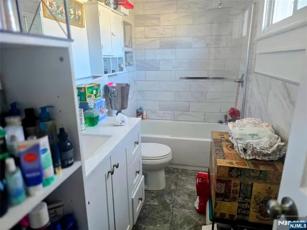 a bathroom with a sink a toilet and curtain