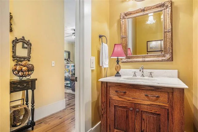 a view of a hallway with wooden floor and furniture