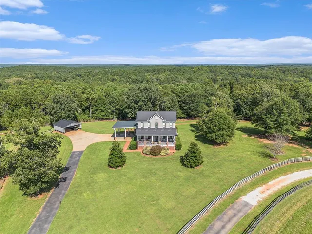 a front view of a house with a yard table and chairs