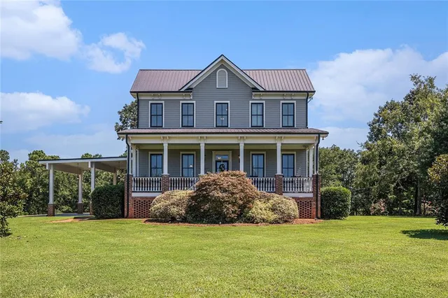 a view of a house with a porch and furniture