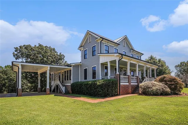 a view of staircase with lots of frames on wall and a wooden floor