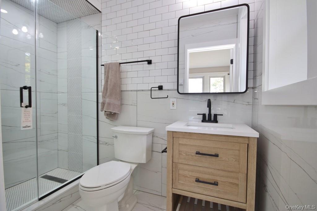 233 Haviland Drive Patterson, NY 12563 - Photo 10 of 19 Updated Bathroom with stall shower and sink with vanity