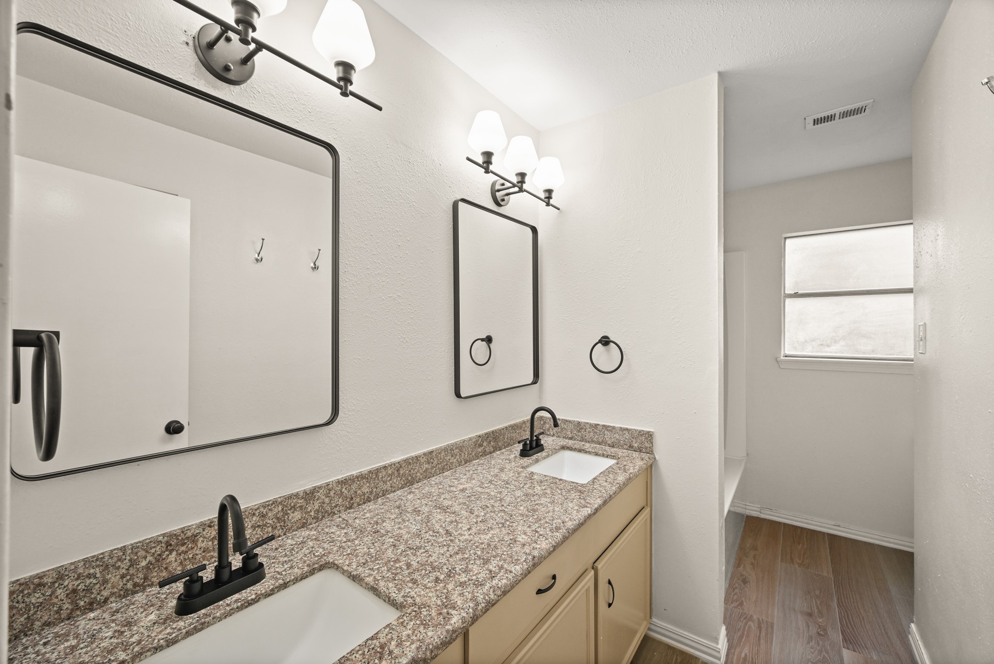 7618 Fountaingrove Lane Spring, TX 77379 - Photo 17 of 20 Updated second-floor bathroom features double sinks and excellent storage—perfect for busy mornings.