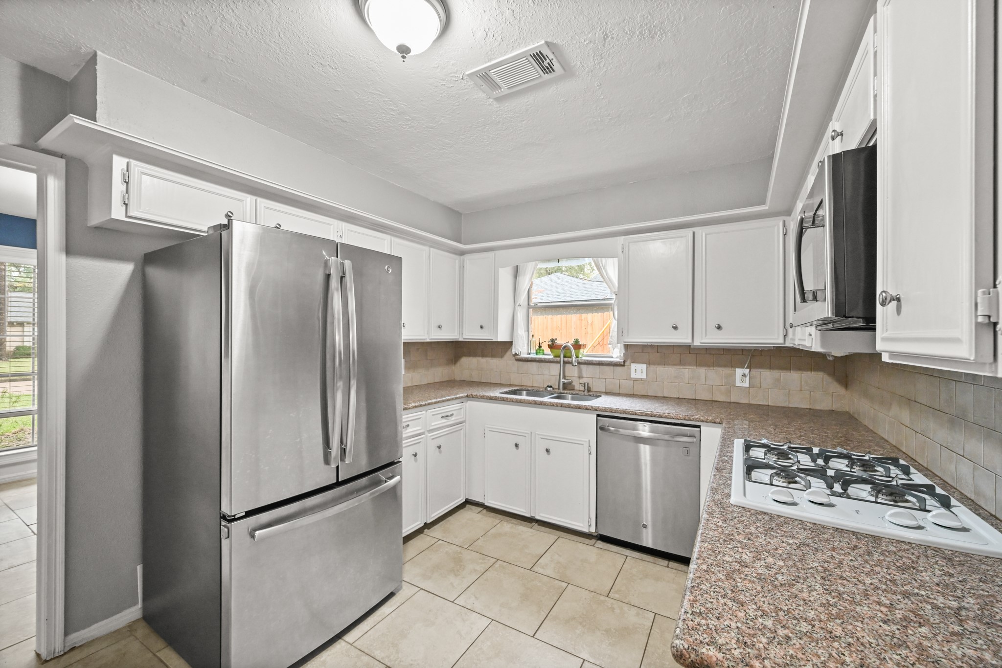 7618 Fountaingrove Lane Spring, TX 77379 - Photo 8 of 20 Updated kitchen with stainless steel appliances, abundant cabinetry, and a functional layout designed for home cooking.