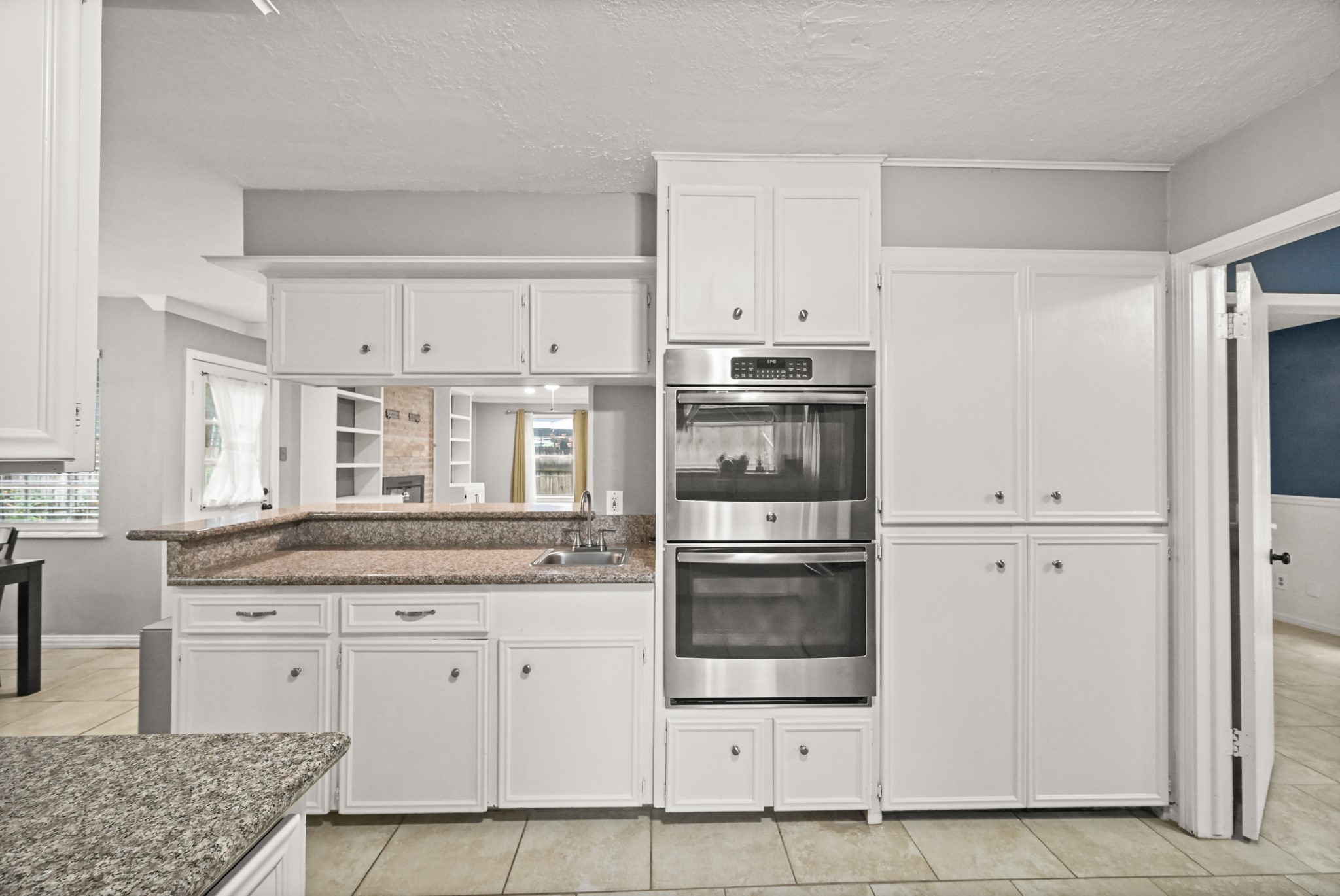 7618 Fountaingrove Lane Spring, TX 77379 - Photo 9 of 20 Open-concept sightlines from the kitchen into the living room, breakfast area, and dining room create a connected, spacious feel.