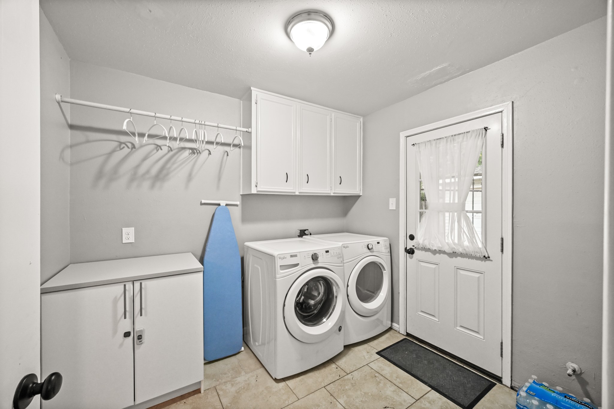 7618 Fountaingrove Lane Spring, TX 77379 - Photo 10 of 20 Oversized laundry room with storage space, washer and dryer included, and direct access to the backyard and half bath.