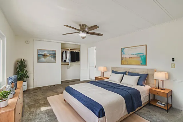 a bathroom with a granite countertop sink toilet a mirror and shower