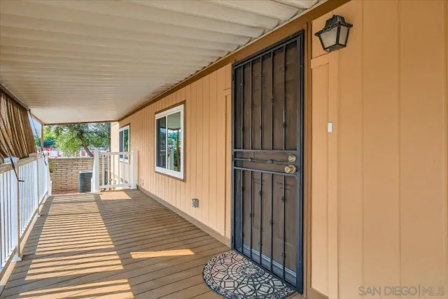 a view of a porch with wooden floor and stairs