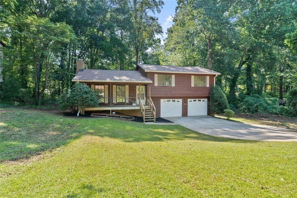 4534 Tifton Court Powder Springs, GA 30127 - Photo 1 of 23 a view of a house with a yard and tree s