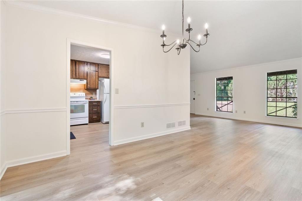 4534 Tifton Court Powder Springs, GA 30127 - Photo 12 of 23 wooden floor in an empty room with a window