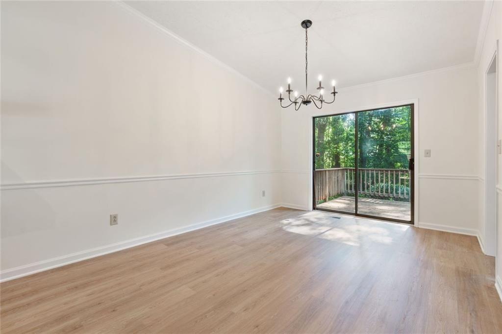 4534 Tifton Court Powder Springs, GA 30127 - Photo 13 of 23 a view of a room with wooden floor ceiling fan and windows