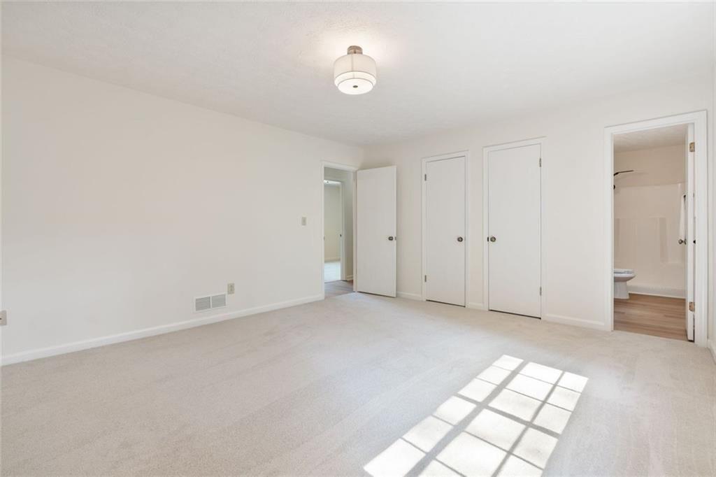 4534 Tifton Court Powder Springs, GA 30127 - Photo 14 of 23 a view of an empty room with window and wooden floor