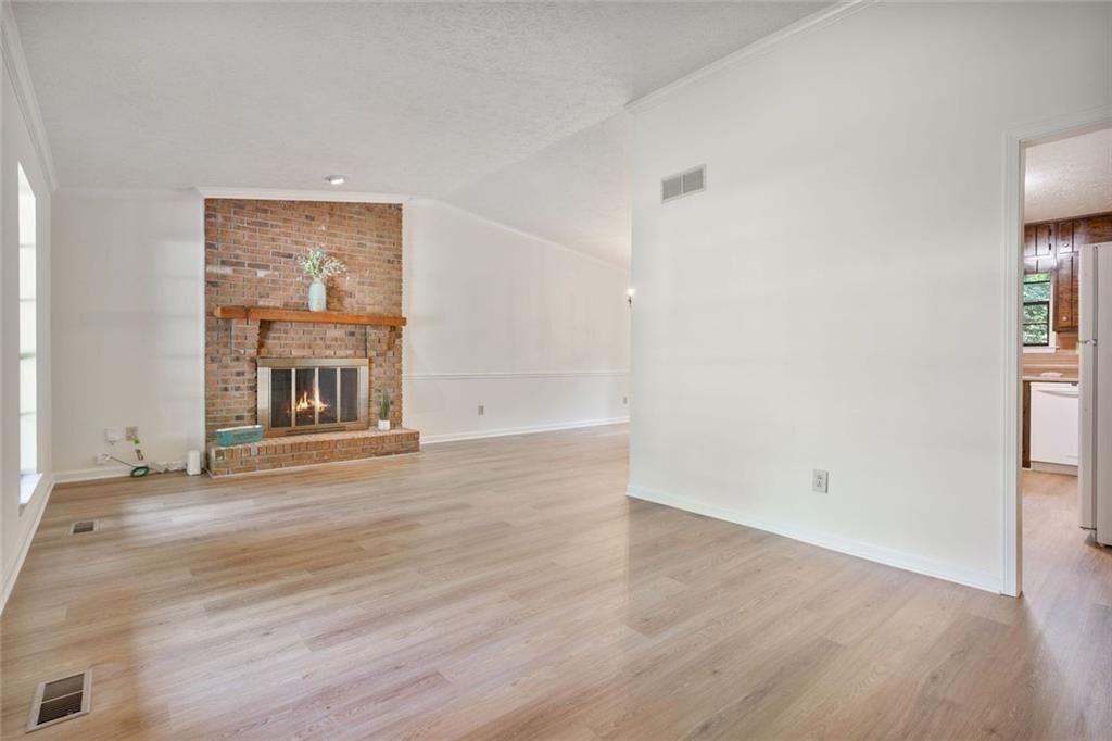 4534 Tifton Court Powder Springs, GA 30127 - Photo 18 of 23 an empty room with wooden floor cabinet and windows