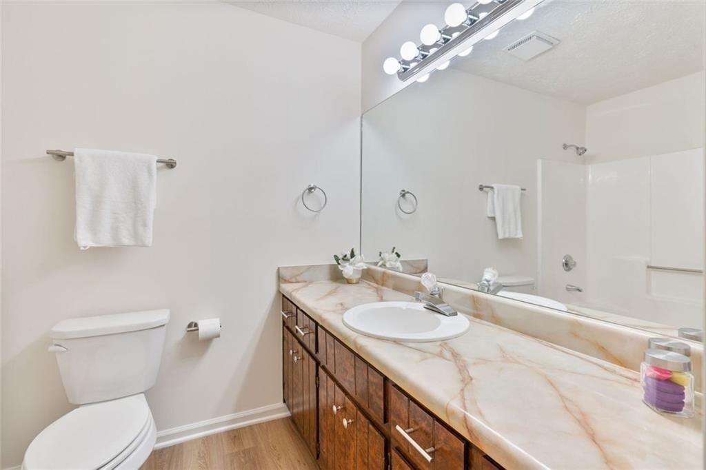 4534 Tifton Court Powder Springs, GA 30127 - Photo 21 of 23 a bathroom with a sink a toilet and a mirror