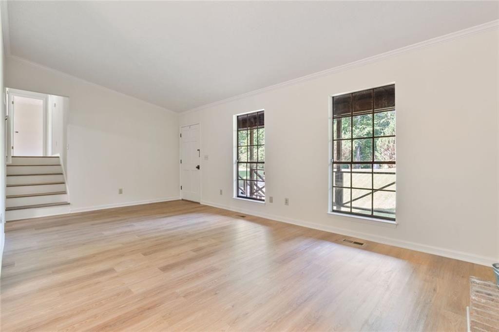 4534 Tifton Court Powder Springs, GA 30127 - Photo 3 of 23 an empty room with wooden floor and windows