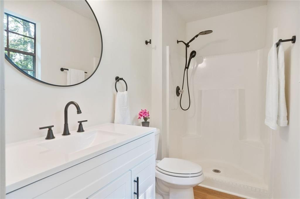 4534 Tifton Court Powder Springs, GA 30127 - Photo 7 of 23 a bathroom with a sink vanity mirror and toilet