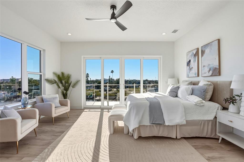 534 Crystal Drive Madeira Beach, FL 33708 - Photo 25 of 68 a spacious bedroom with a bed a couch and a large window