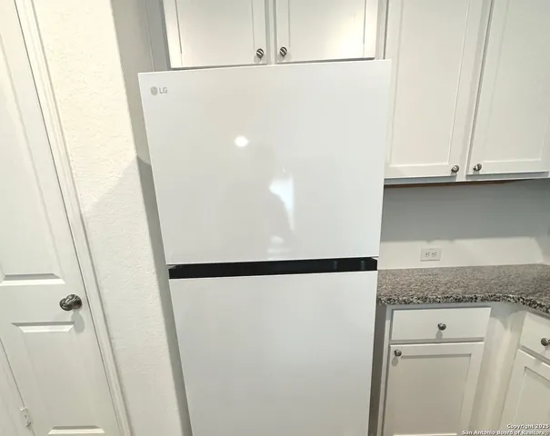 a stove sitting inside of a kitchen with granite countertop