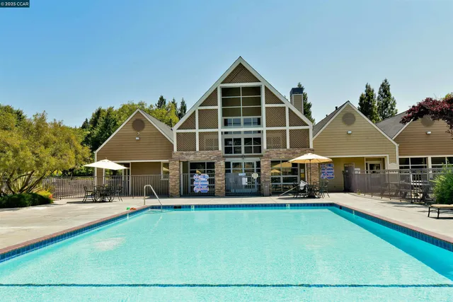 a front view of a house with yard and green space