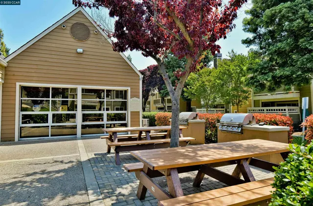 a view of a deck with table and chairs with wooden floor and fence