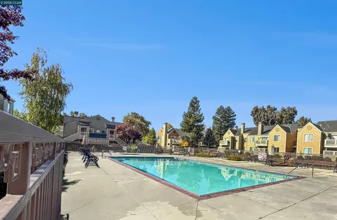 a view of a swimming pool and lounge chairs