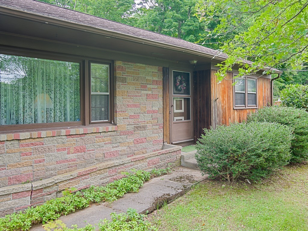 107 Mine Brook Road Webster, MA 01570 - Photo 2 of 30 a front view of a house with a garden