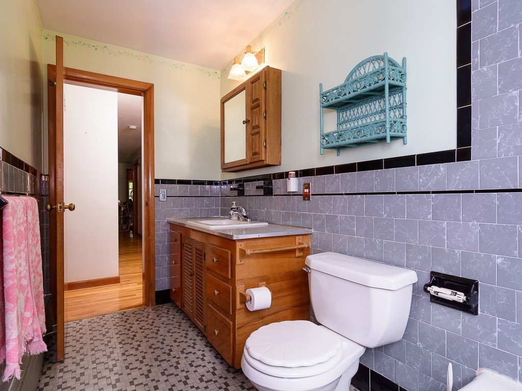 107 Mine Brook Road Webster, MA 01570 - Photo 23 of 30 a bathroom with a granite countertop toilet sink and mirror