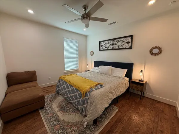 a bedroom with a bed and a couch