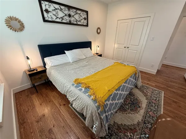 a bedroom with a bed and wooden floor