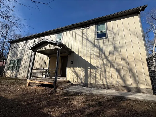 a view of a house with a large tree