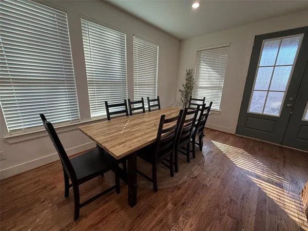 a dining room with furniture and wooden floor