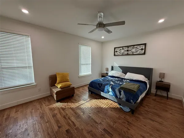 a spacious bedroom with a bed and a window