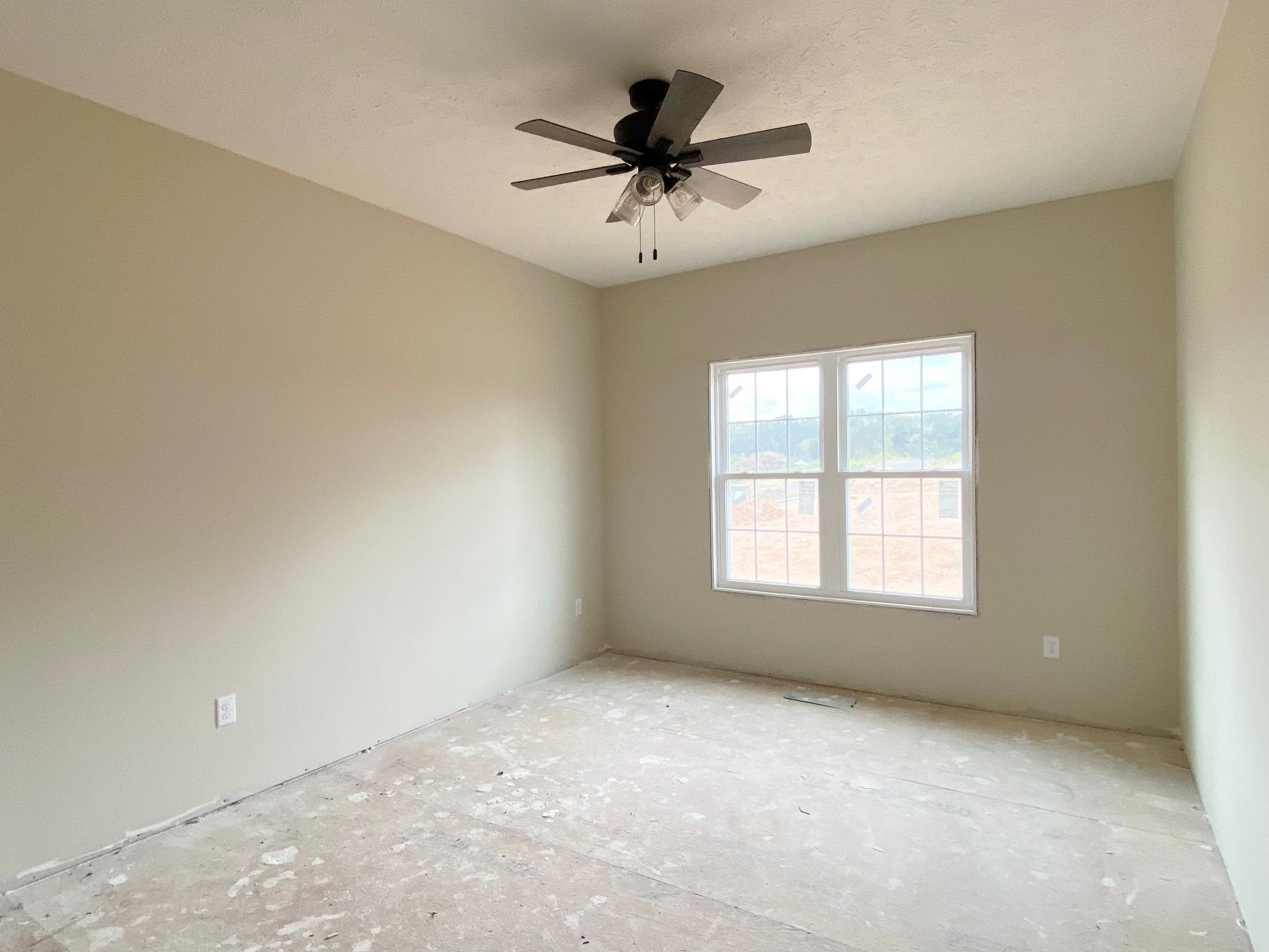 122 Spring Ridge Drive Stuarts Draft, VA 24477 - Photo 15 of 16 an empty room with a ceiling fan and window