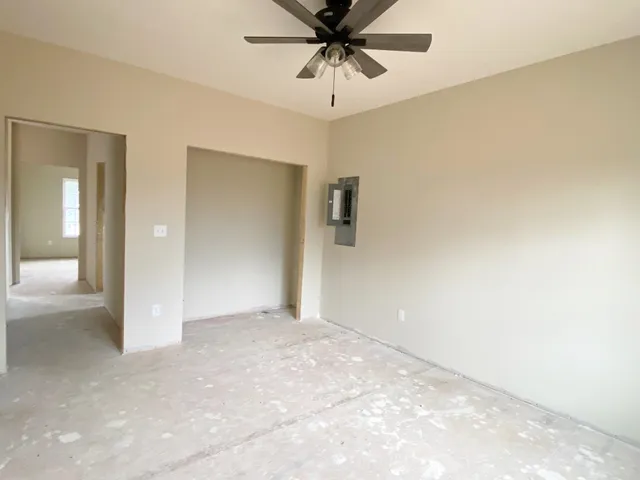 a view of a hallway with a chandelier fan