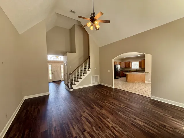 a view of an empty room with wooden floor