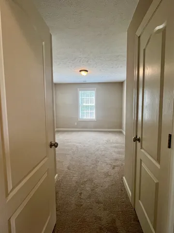 an empty room with windows and closet