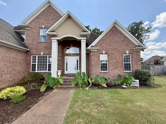 a front view of a house with garden