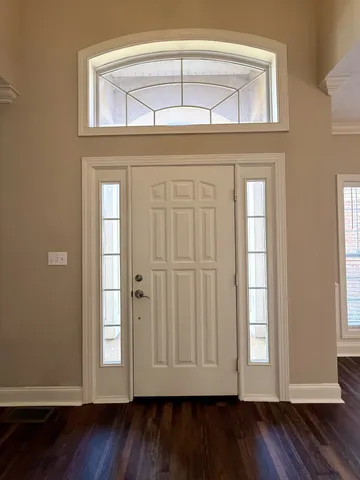 an entryway with wooden floor