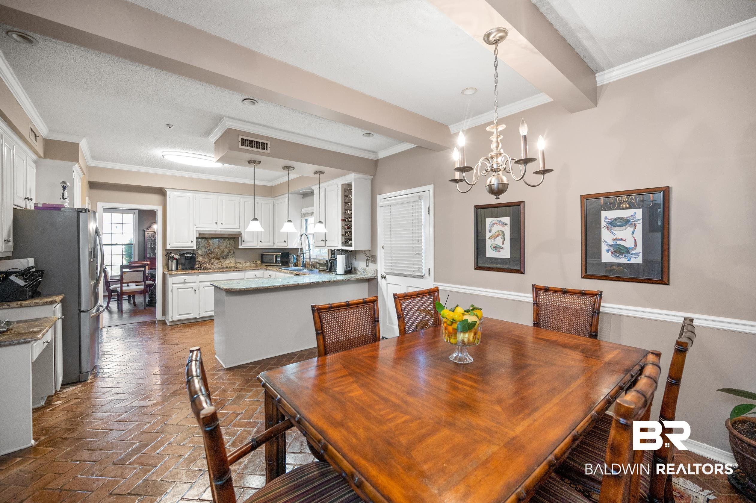 6705 Ridgeland Road South Mobile, AL 36695 - Photo 13 of 44 Dining room featuring crown molding and a notable chandelier