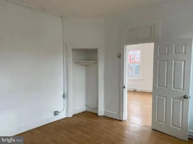 a view of an empty room and wooden floor
