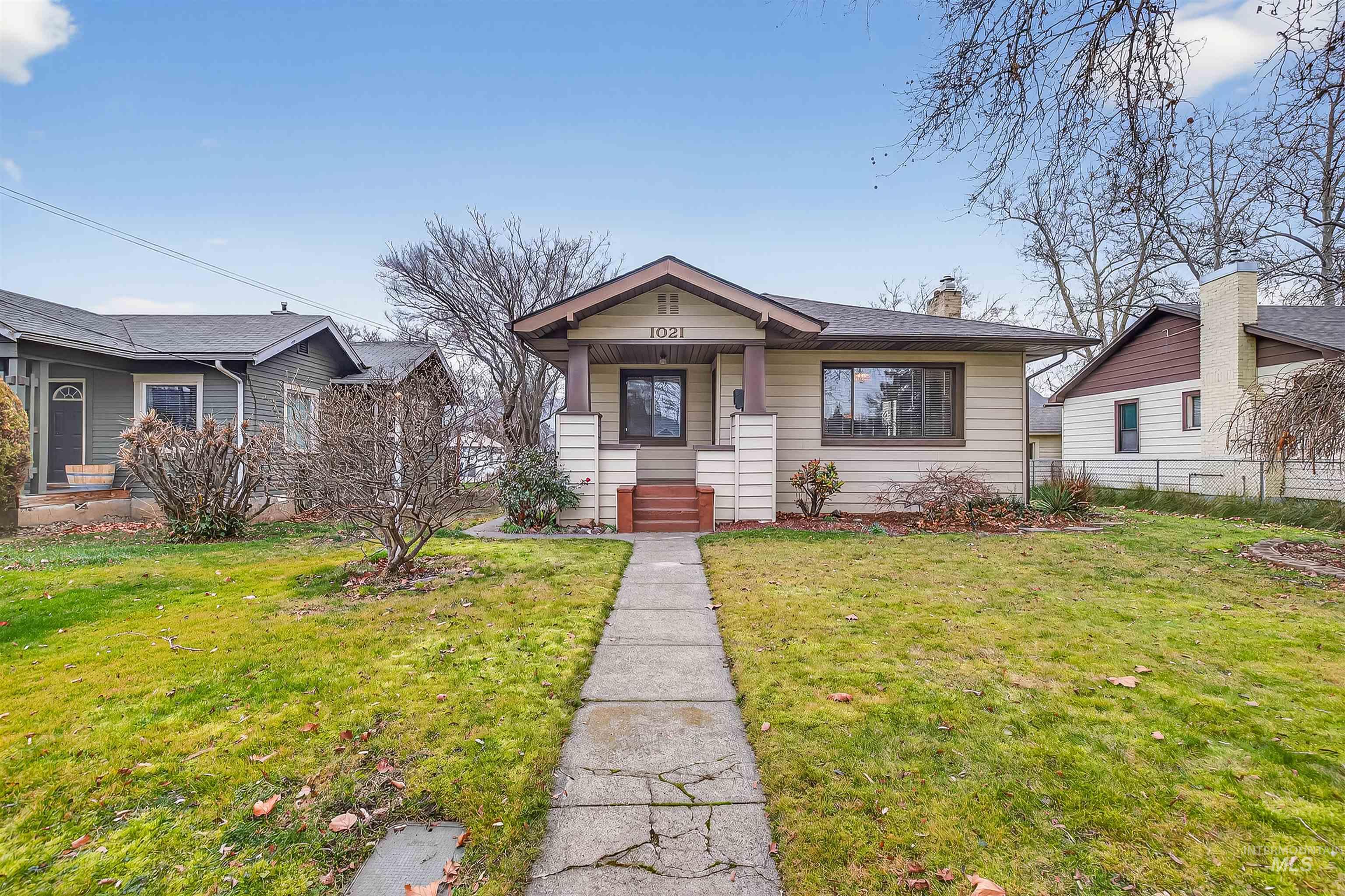 1021 11th Avenue Lewiston, ID 83501 - Photo 1 of 41 Bungalow-style home with a front lawn, a chimney, and a porch