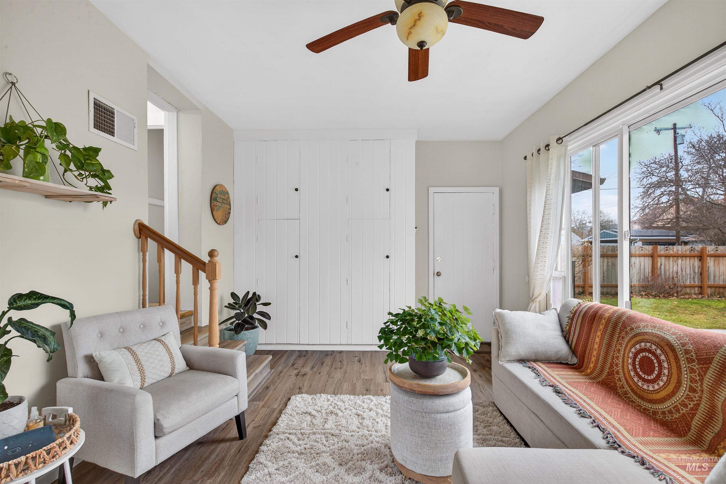 1021 11th Avenue Lewiston, ID 83501 - Photo 14 of 41 Living room with wood finished floors, a ceiling fan, and stairs