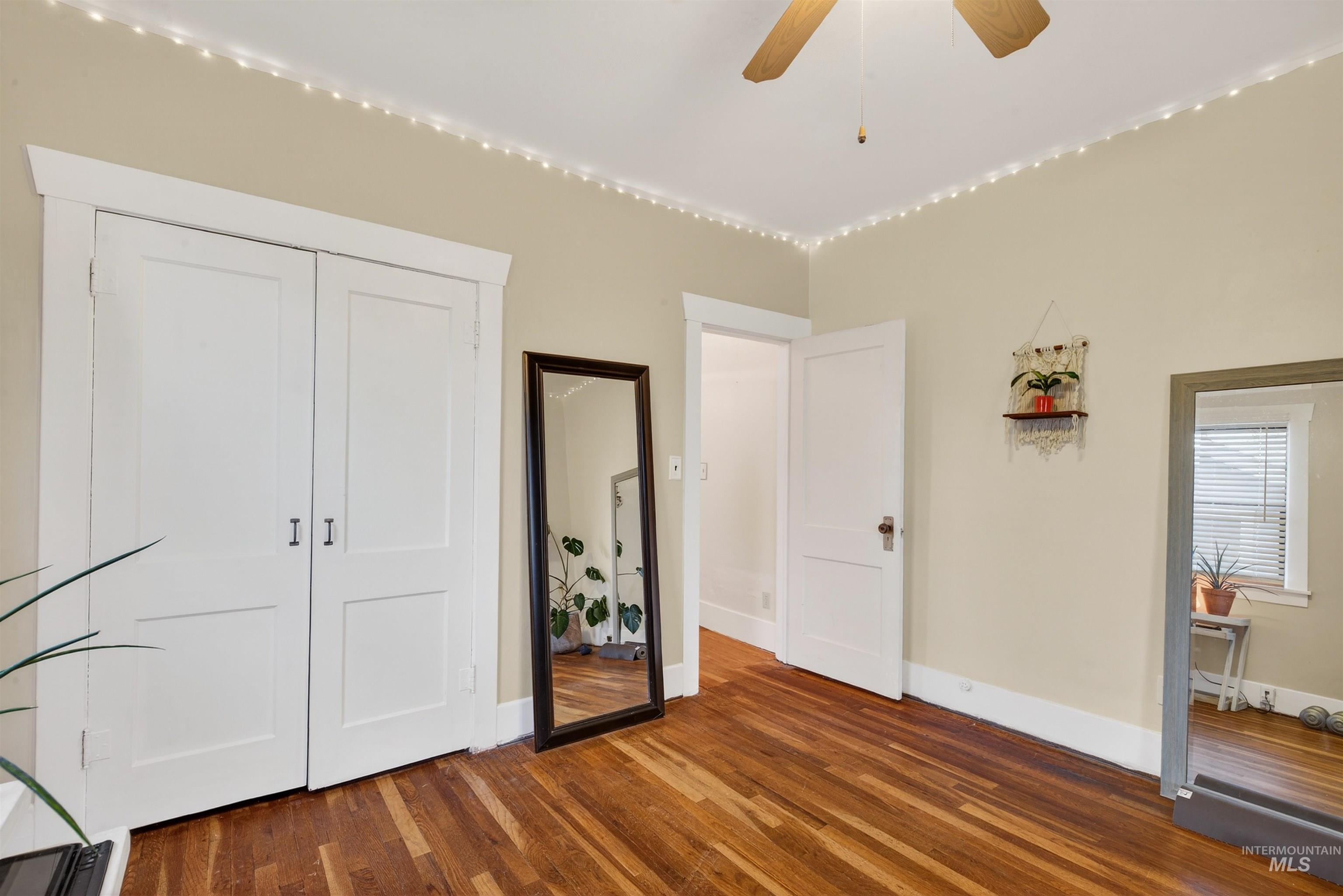 1021 11th Avenue Lewiston, ID 83501 - Photo 19 of 41 Unfurnished bedroom featuring dark wood finished floors, a closet, and ceiling fan