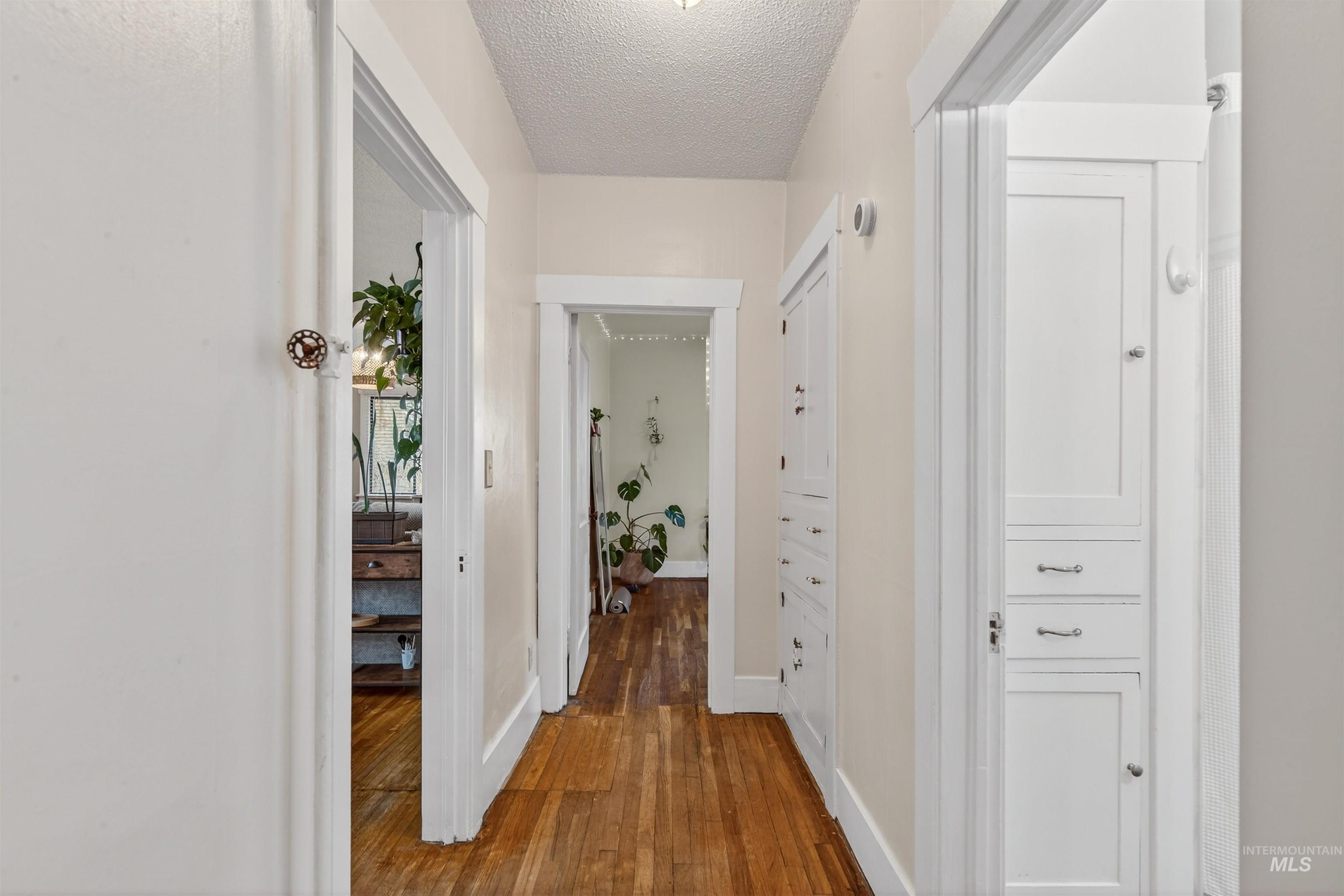 1021 11th Avenue Lewiston, ID 83501 - Photo 20 of 41 Hallway with dark wood-style floors and a textured ceiling