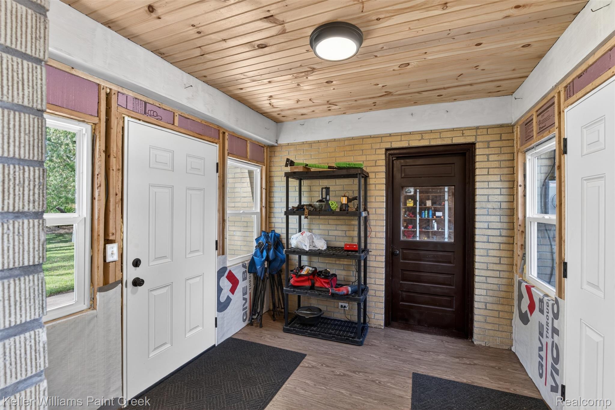 2942 Tatham Road Saginaw, MI 48601 - Photo 27 of 59 Entryway featuring wooden ceiling, light wood-style floors, and brick wall