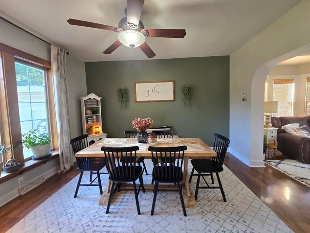 a view of a dining room with furniture window and wooden floor